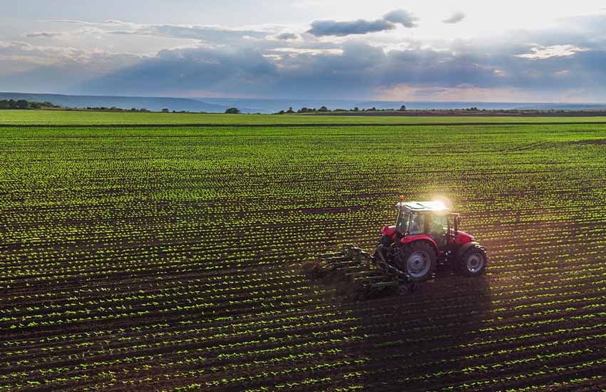 Tractor working across a planted field